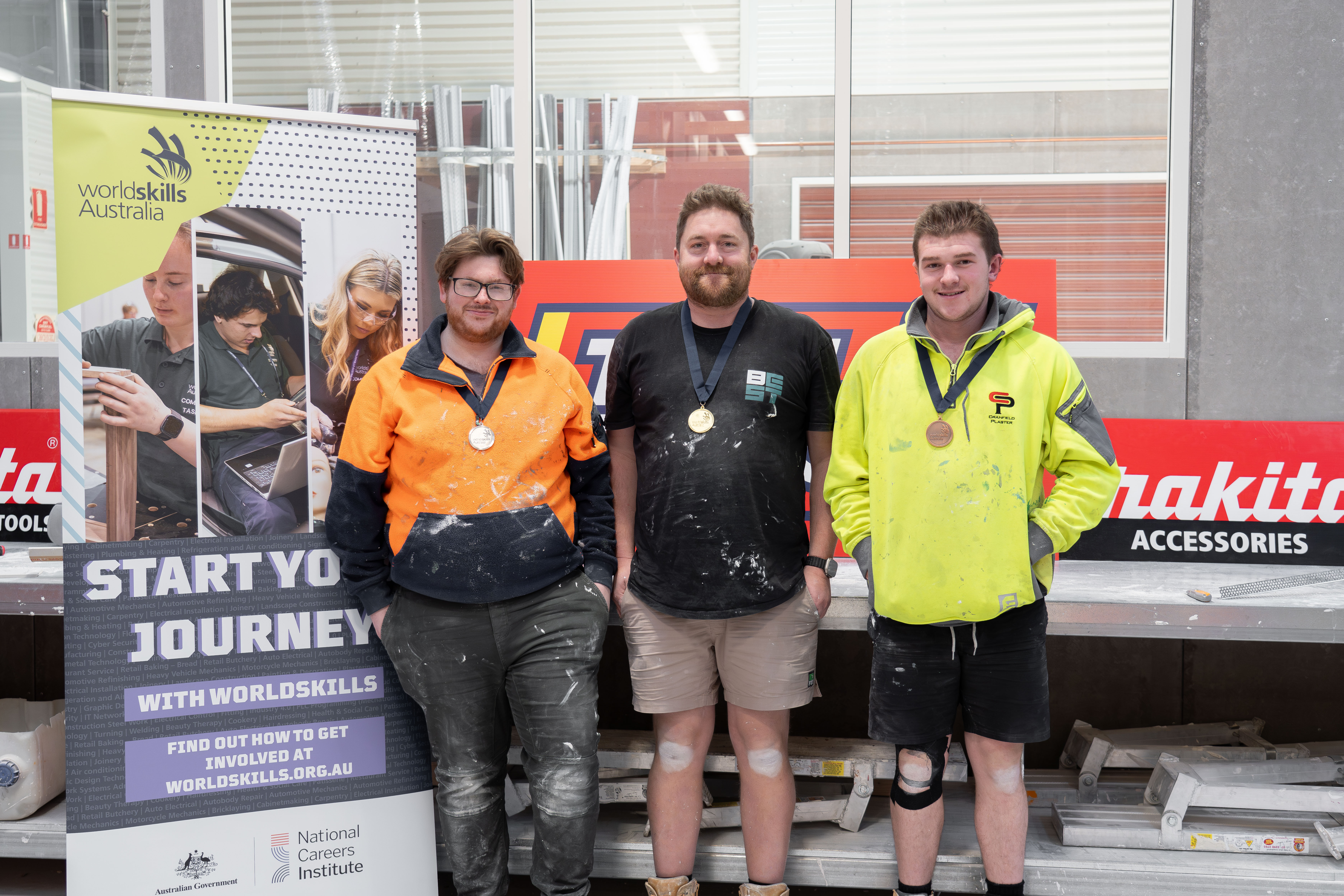 Brodie masters and other medal winners pose for a photo with their WorldSkills medals around their necks