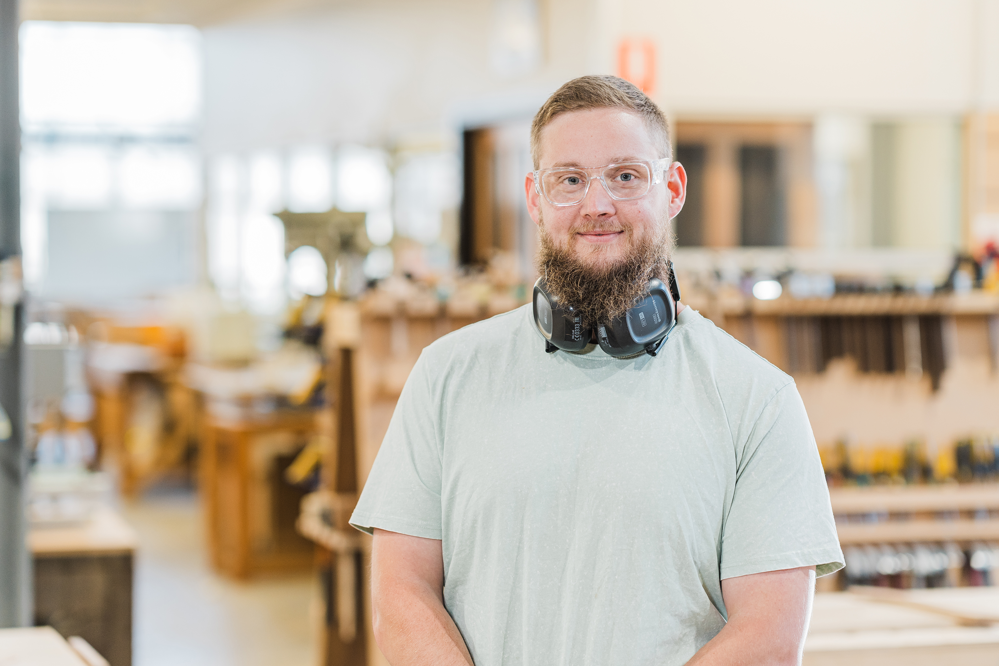 TasTAFE Teacher Joshua Boon wearing safety glasses with earmuffs around his neck