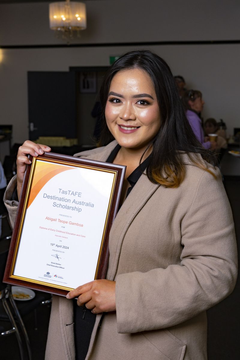 Woman holding a framed certificate