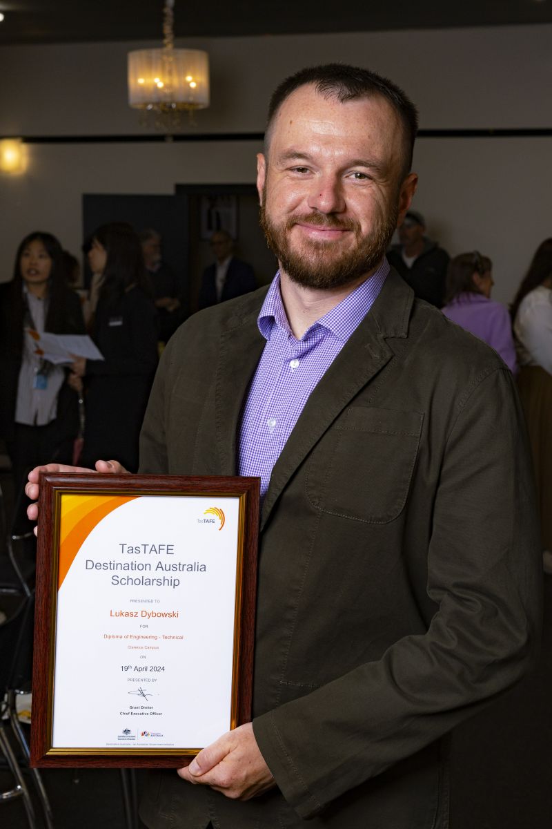 man holding a framed certificate