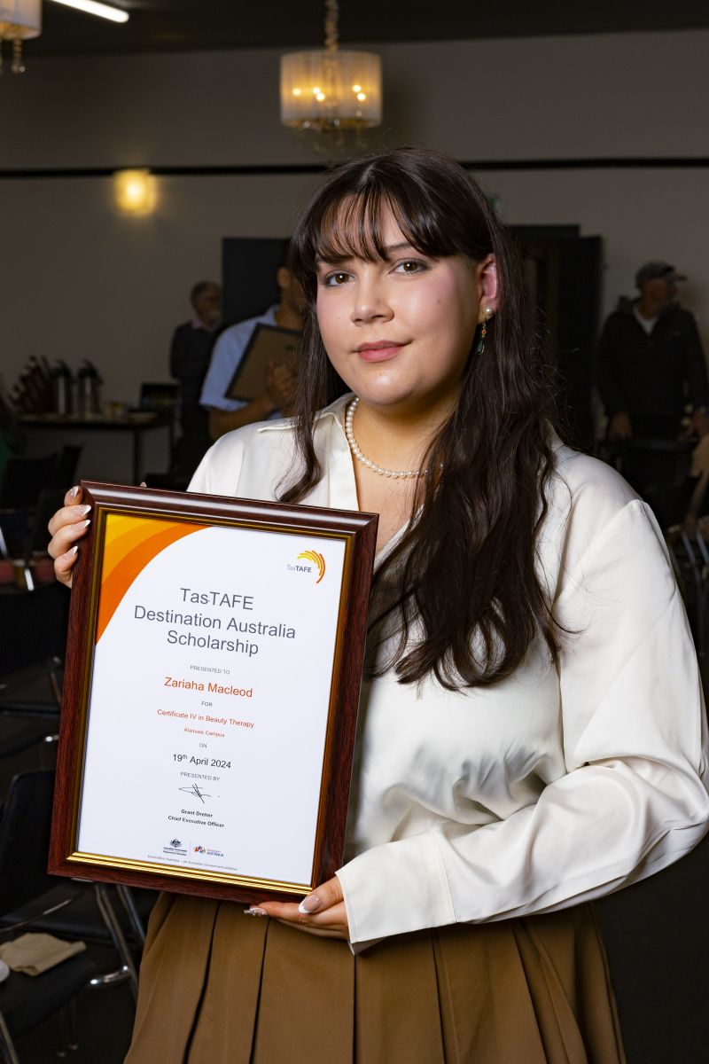 Woman holding a framed certificate