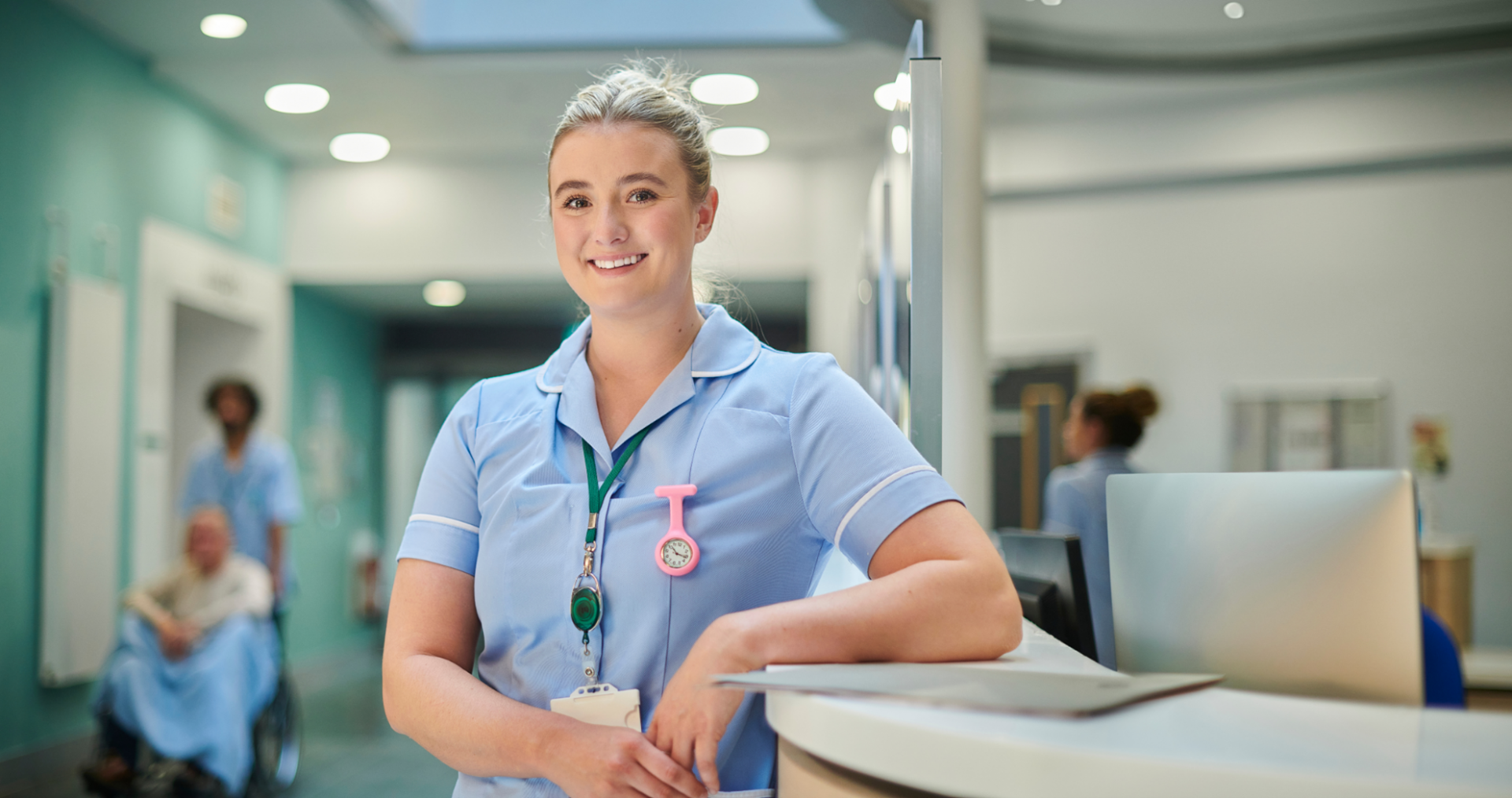 nurse leaning on counter in a hospital