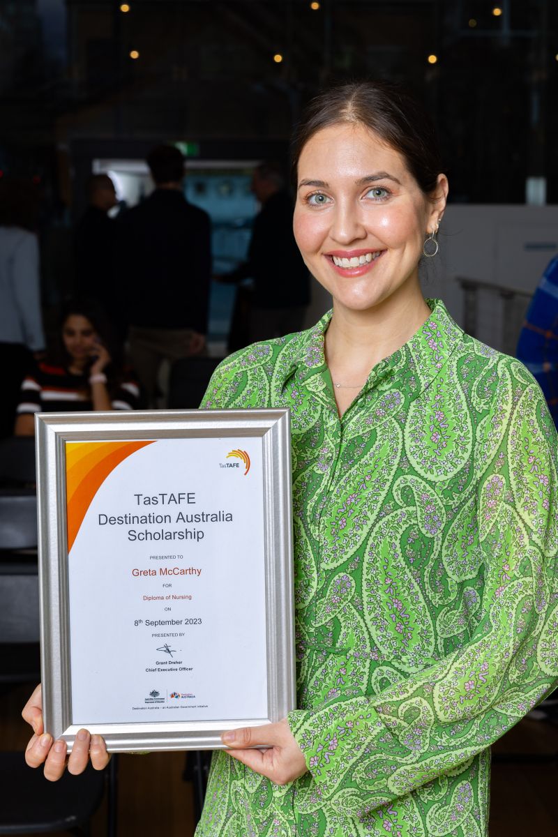 Greta McCarthy holding here Destination Australia scholarship certificate